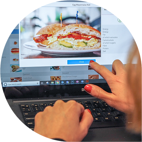 Parent checking meal nutritional information on the laptop at home